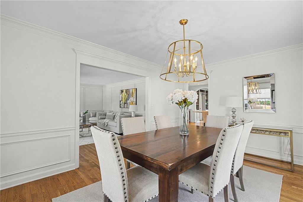 3819 North Stratford Road Northeast Atlanta, GA 30342 - Photo 7 of 48 a view of a dining room with furniture a chandelier and wooden floor