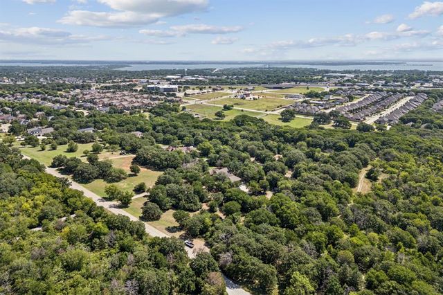 an aerial view of a residential houses with city view