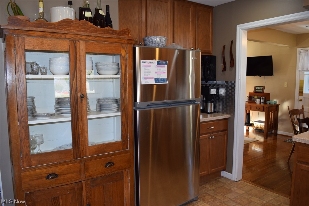 65578 Mathews Road Cambridge, OH 43725 - Photo 9 of 40 Kitchen featuring light tile floors, stainless steel refrigerator, and backsplash