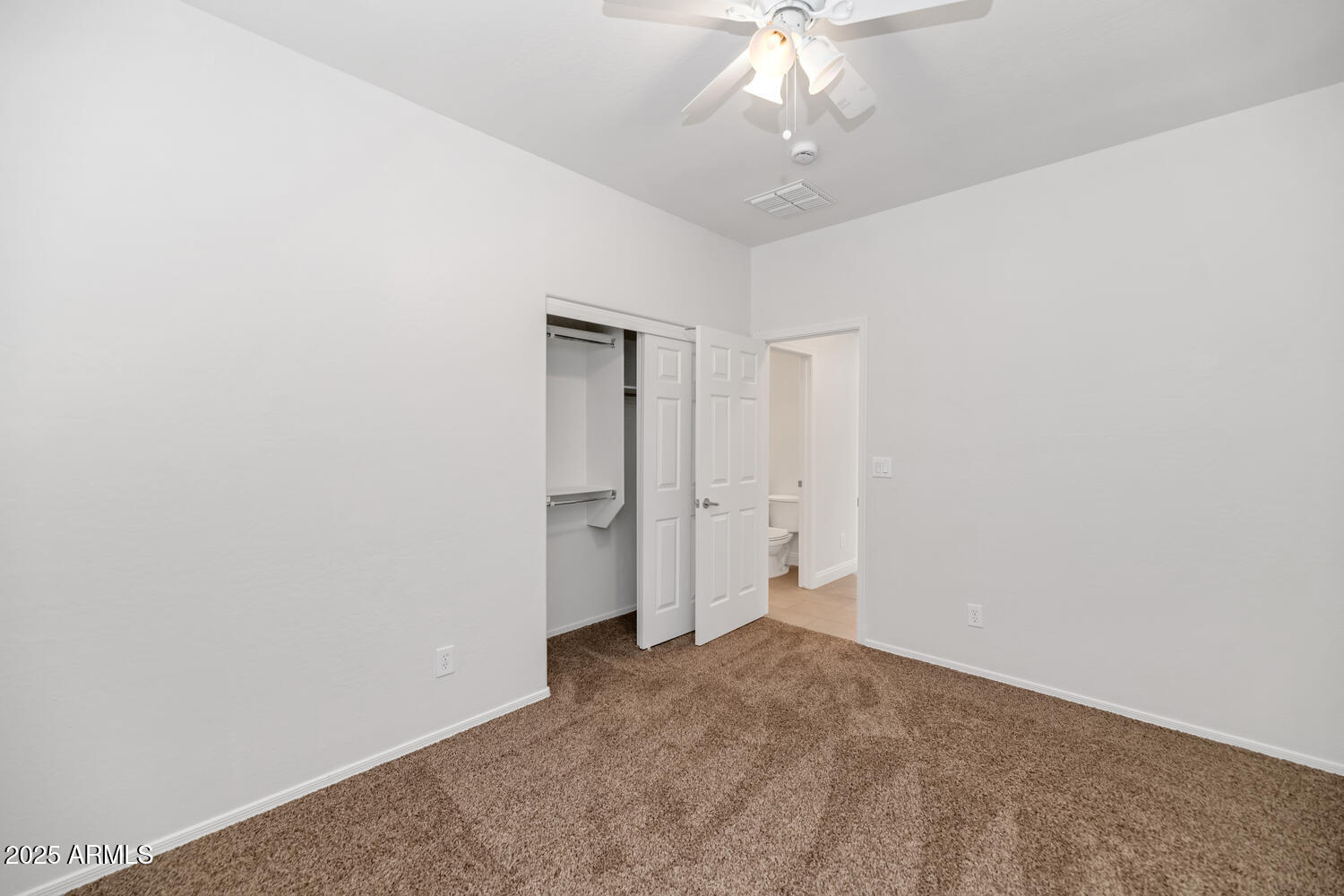 39148 North Acadia Way Anthem, AZ 85086 - Photo 18 of 34 an empty room with a chandelier fan