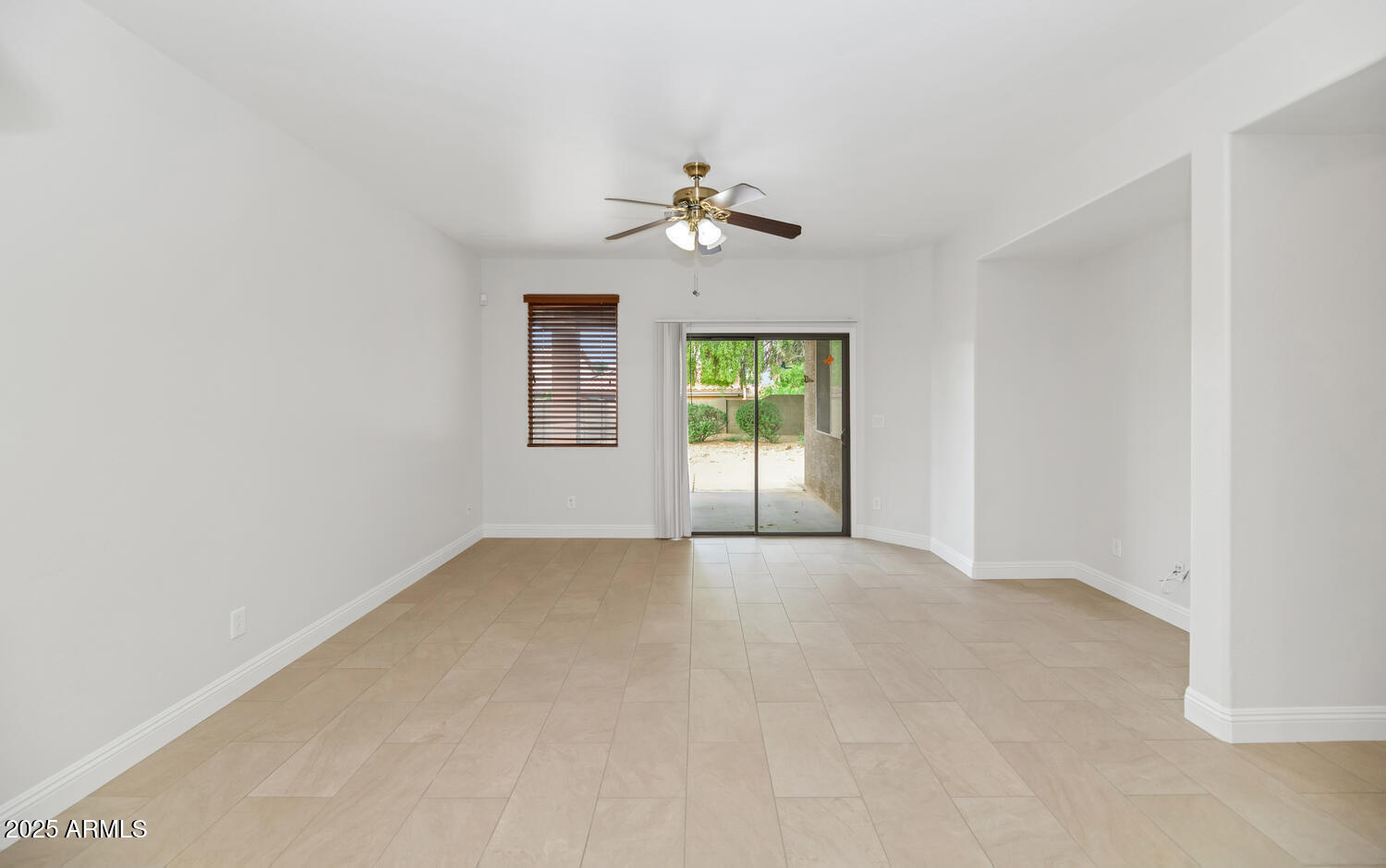 39148 North Acadia Way Anthem, AZ 85086 - Photo 4 of 34 an empty room with chandelier fan and windows