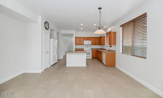 a kitchen with stainless steel appliances granite countertop a stove and a refrigerator