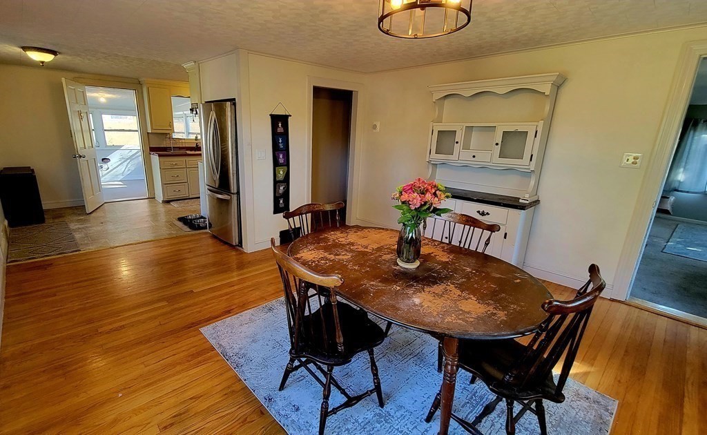 11 North Martin Road Amesbury, MA 01913 - Photo 11 of 28 a view of a dining room with furniture and wooden floor