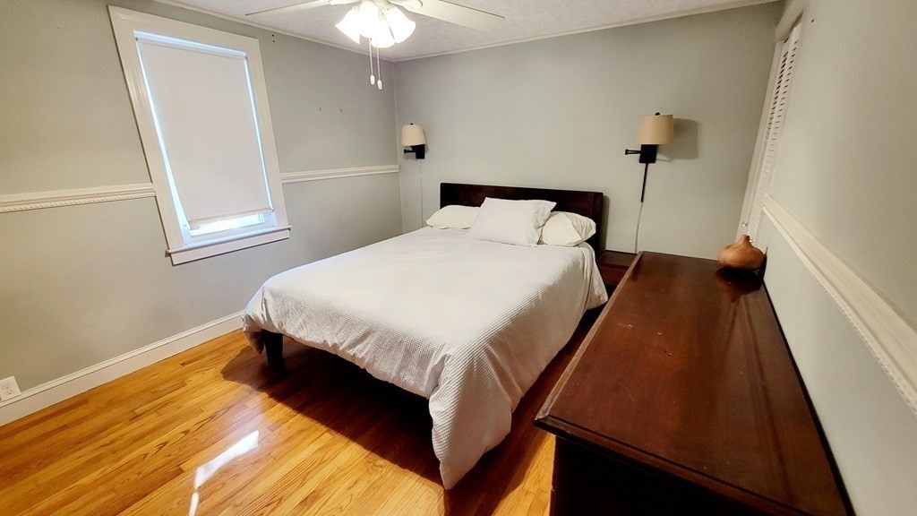 11 North Martin Road Amesbury, MA 01913 - Photo 13 of 28 a bed sitting in a bedroom next to a window