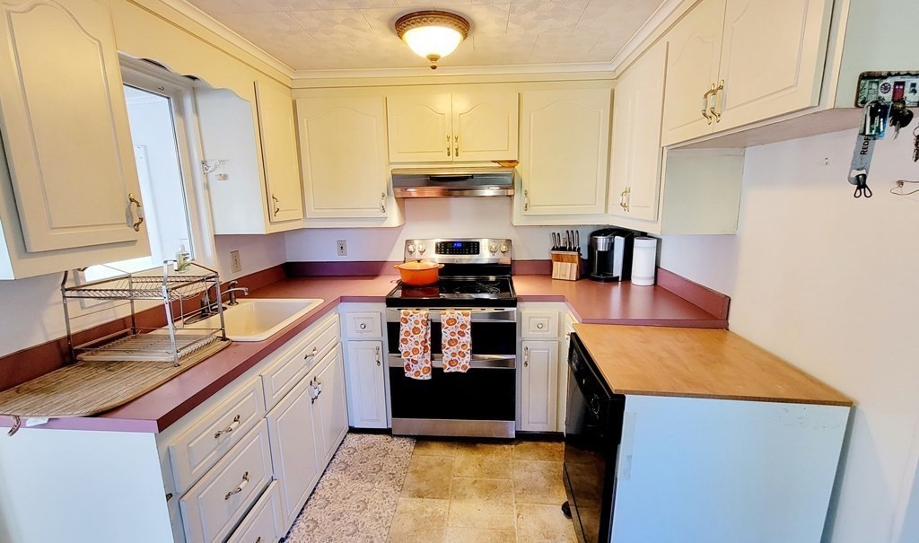 11 North Martin Road Amesbury, MA 01913 - Photo 7 of 28 a kitchen with stainless steel appliances granite countertop a sink stove and refrigerator