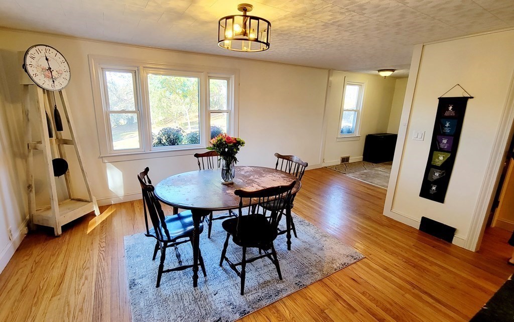 11 North Martin Road Amesbury, MA 01913 - Photo 10 of 28 a view of a dining room with furniture window and wooden floor