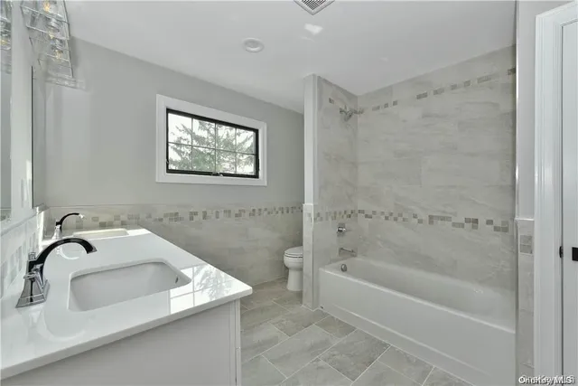 a bathroom with a sink a bathtub and a shower