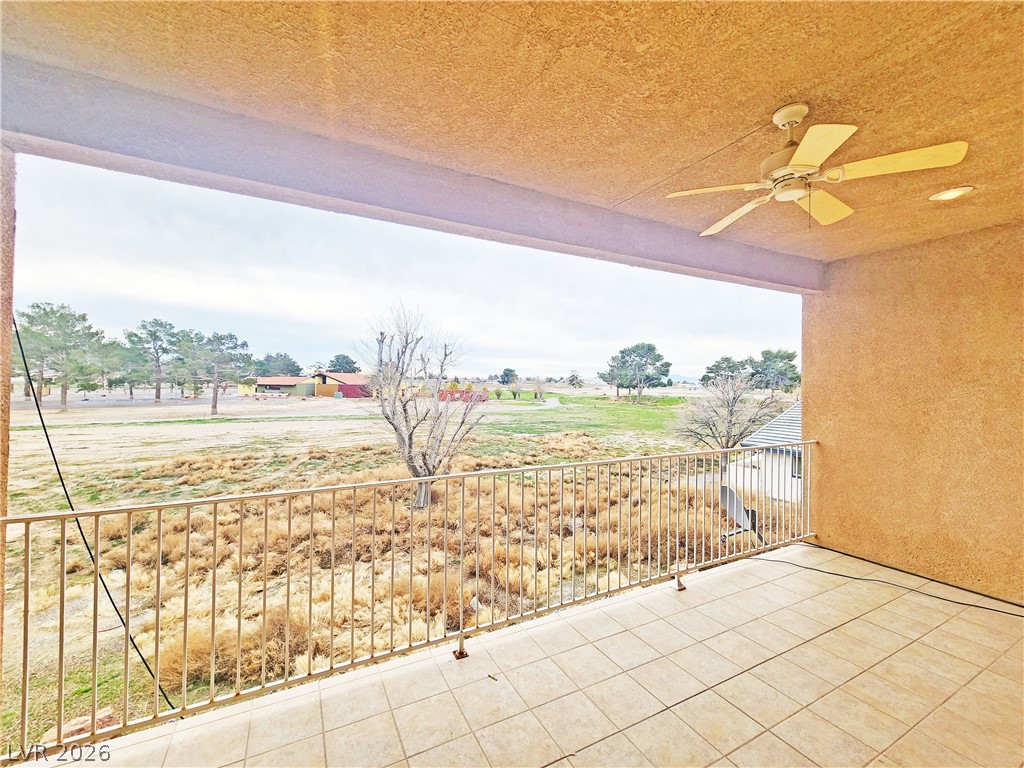 1421 Star Road, Unit 2 Pahrump, NV 89048 - Photo 27 of 33 View of patio with a ceiling fan and a balcony
