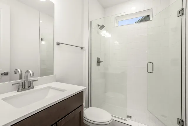 a bathroom with a sink toilet and shower