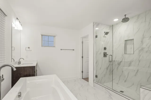 a bathroom with a bathtub and shower