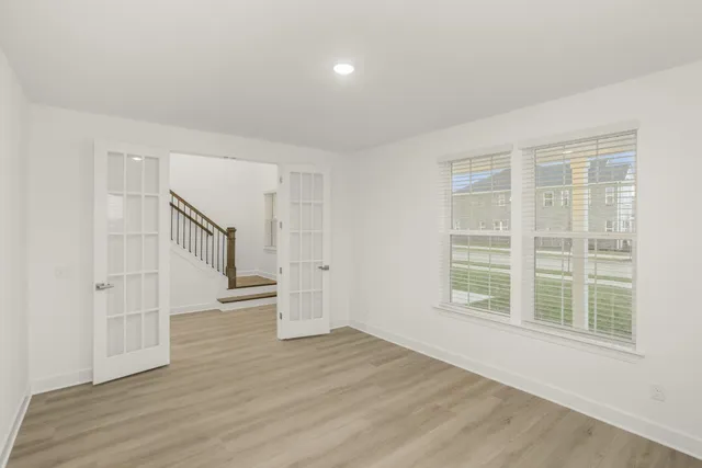 wooden floor in an empty room with a window