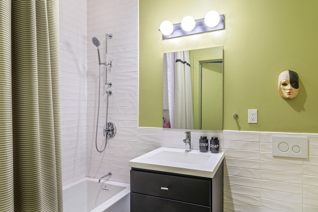 51 Lafayette Street, Unit 403 Salem, MA 01970 - Photo 11 of 13 a bathroom with a sink a toilet and shower