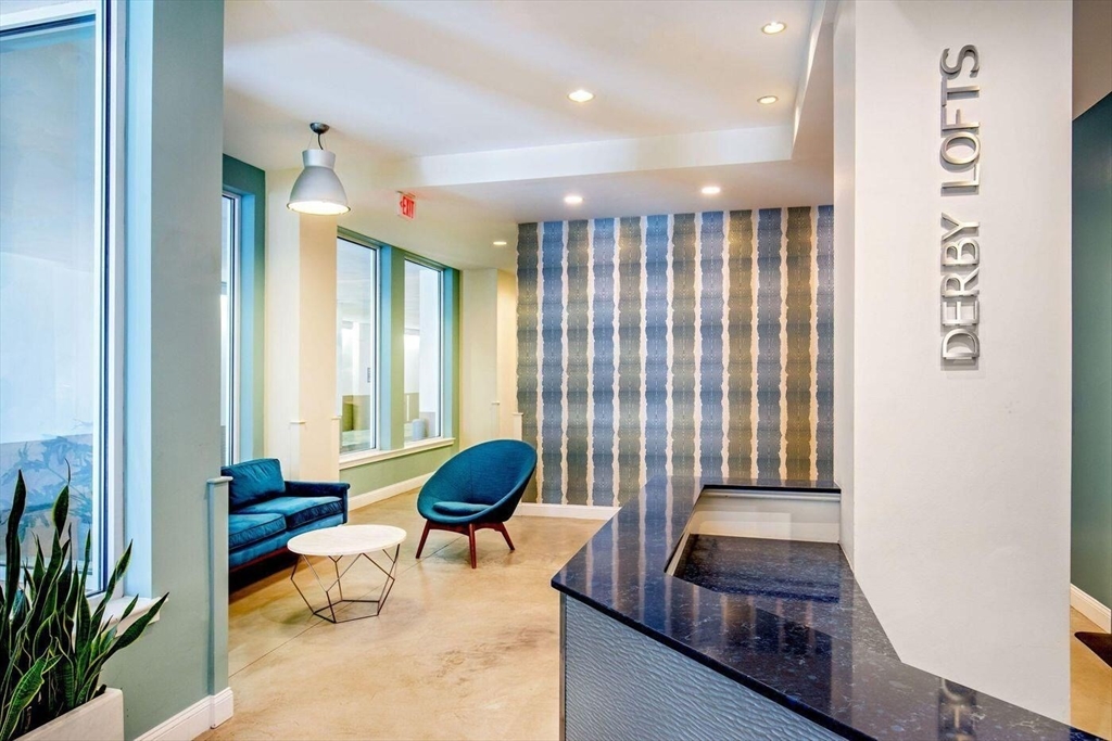 51 Lafayette Street, Unit 403 Salem, MA 01970 - Photo 2 of 13 a living room with furniture and a large window