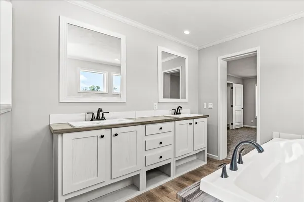 a spacious bathroom with a granite countertop sink mirror and a bathtub