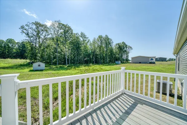 a view of a house with backyard and porch