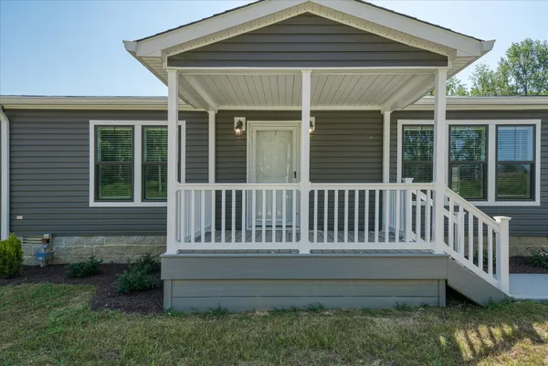 a view of backyard with swimming pool and outdoor seating