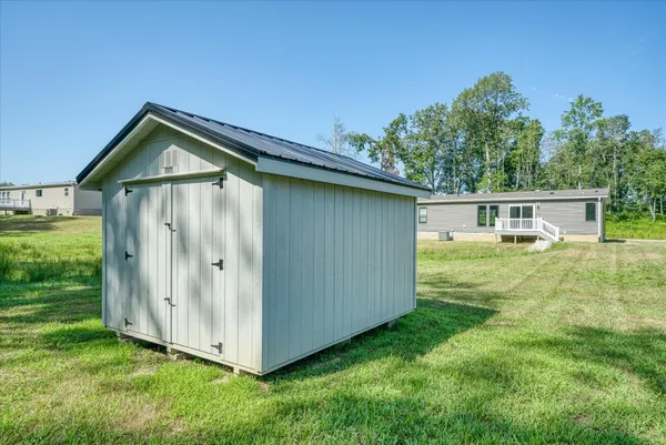 a view of a house with a yard and garage