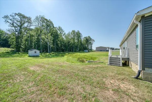 a view of a house with a yard and a garden