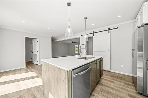 a kitchen with a stove a refrigerator and a sink