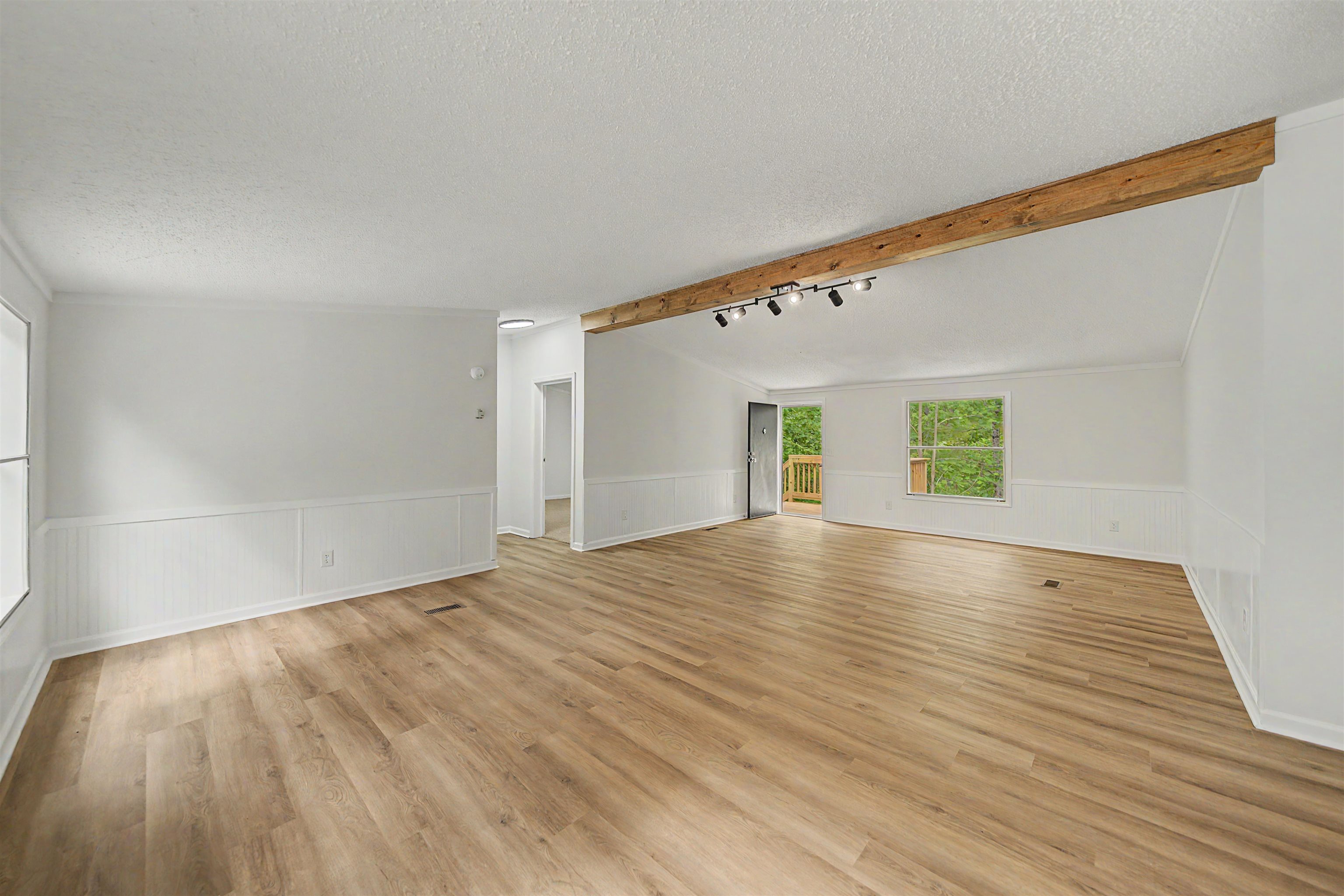 890 Burks Road Savannah, TN 38372 - Photo 5 of 40 a view of an empty room with wooden floor and a window