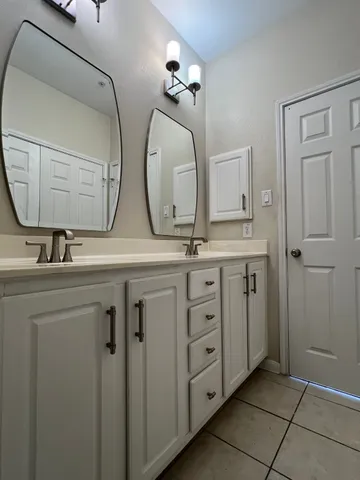 a bathroom with a toilet a sink and mirror