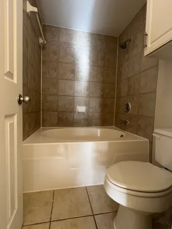 a bathroom with a toilet and a bath tub