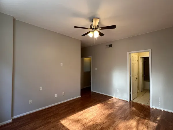 a view of empty room with wooden floor