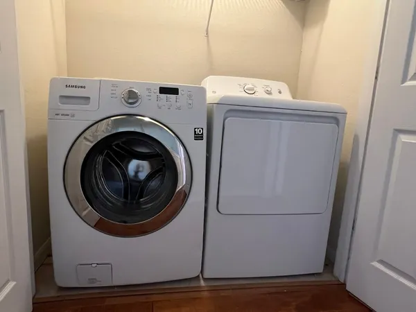 an entryway with wooden floor and a mirror