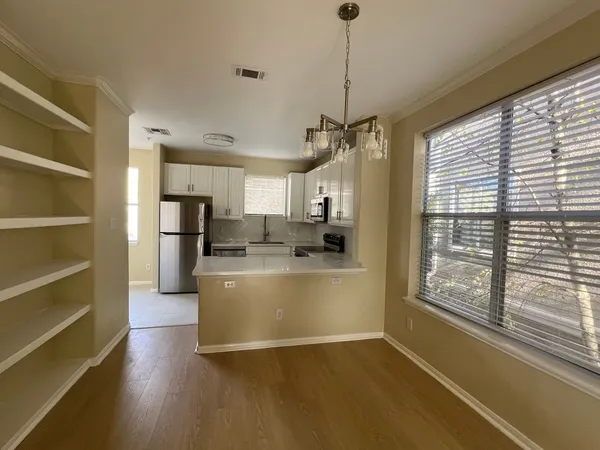 a view of kitchen with stainless steel appliances granite countertop a stove and a refrigerator