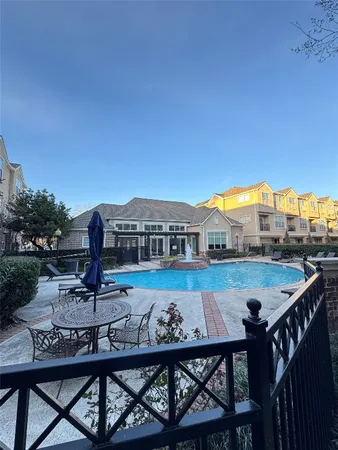 a front view of a house with garden and sitting area