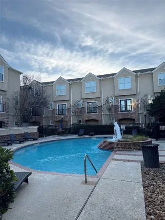 a view of a house with swimming pool and sitting area