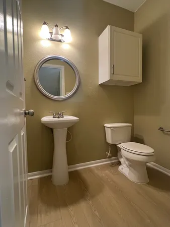 a bathroom with a toilet sink and mirror