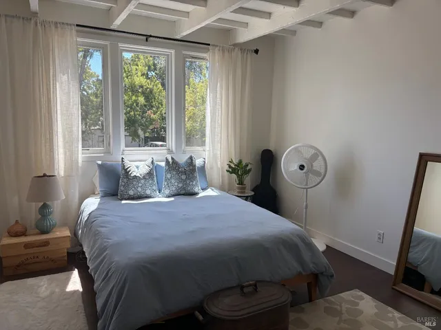 a bedroom with a bed and a window