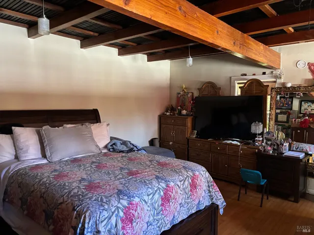 a bedroom with a bed and a flat screen tv