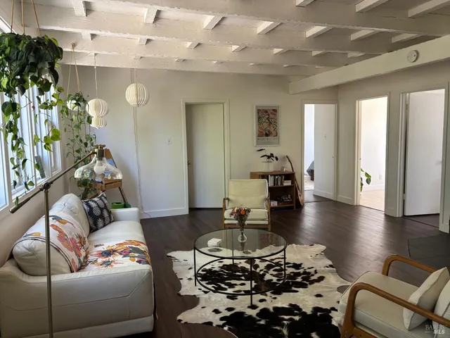 a living room with furniture and a chandelier