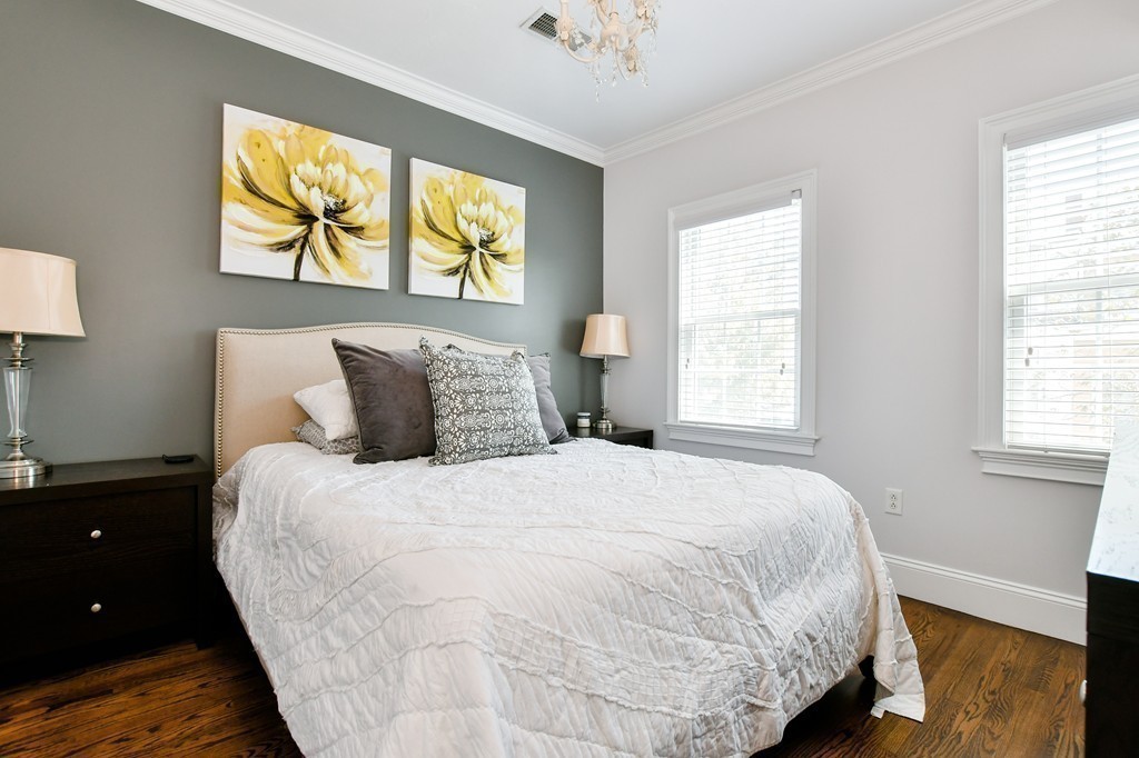 155 H Street, Unit 2 Boston, MA 02127 - Photo 11 of 20 a large bed sitting in a bedroom next to a window