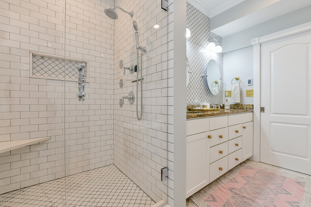 155 H Street, Unit 2 Boston, MA 02127 - Photo 13 of 20 a bathroom with a double vanity sink a toilet and shower