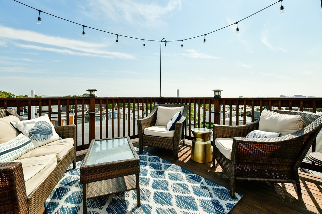 155 H Street, Unit 2 Boston, MA 02127 - Photo 17 of 20 a roof deck with a couch and chairs