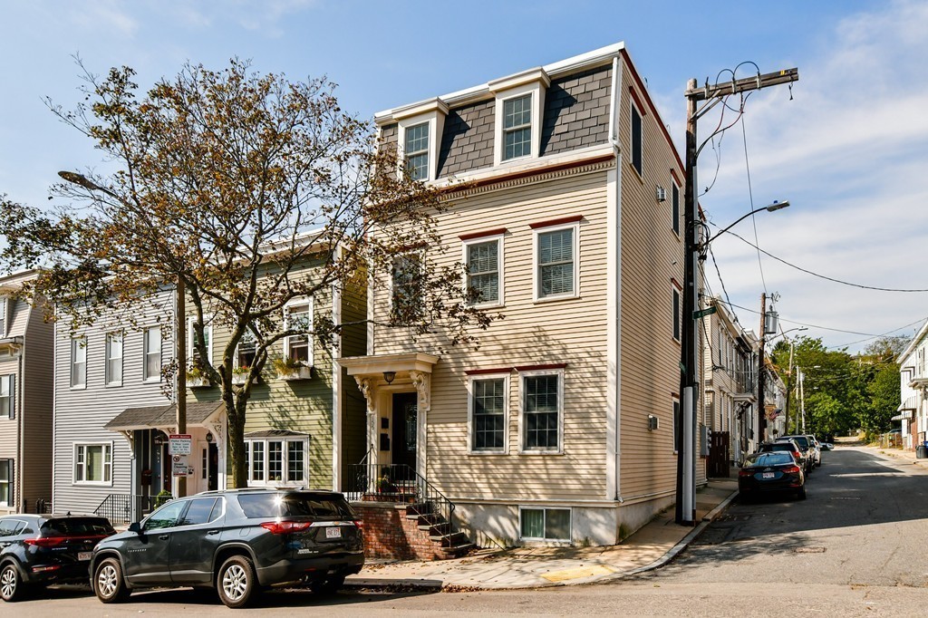 155 H Street, Unit 2 Boston, MA 02127 - Photo 19 of 20 a front view of a residential apartment building with a yard