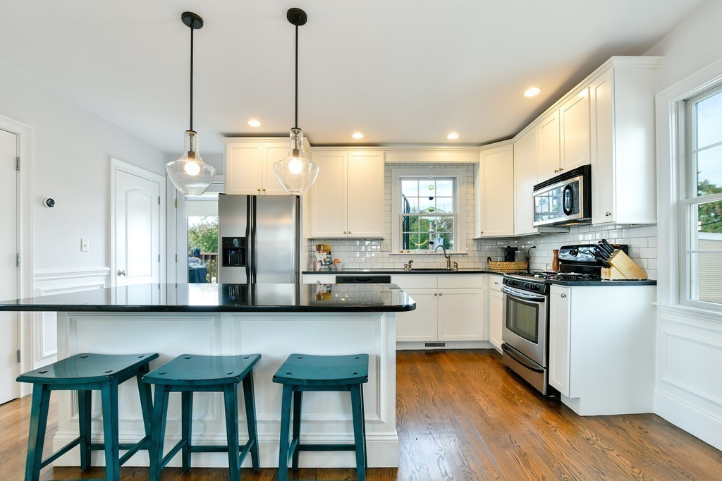 155 H Street, Unit 2 Boston, MA 02127 - Photo 6 of 20 a kitchen with granite countertop a table chairs microwave and cabinets