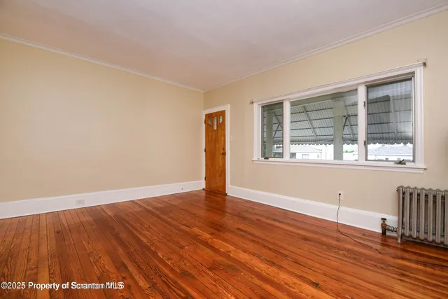 a view of a big house with a big yard and large trees