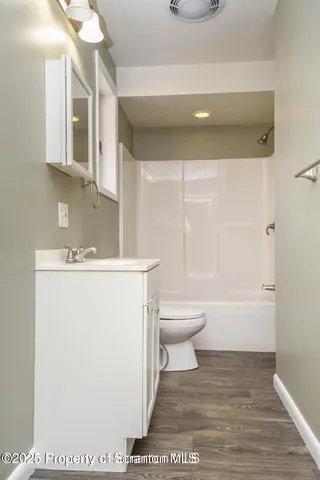 a bathroom with a toilet a sink and bathtub