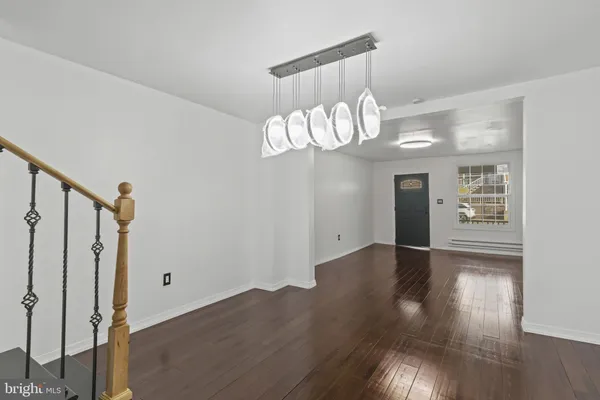 a view of a room with wooden floor