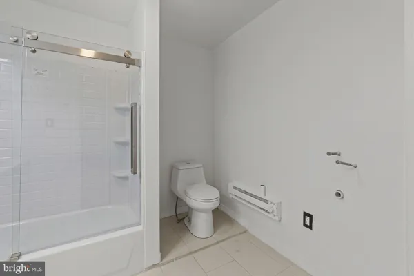 a bathroom with a shower and a toilet