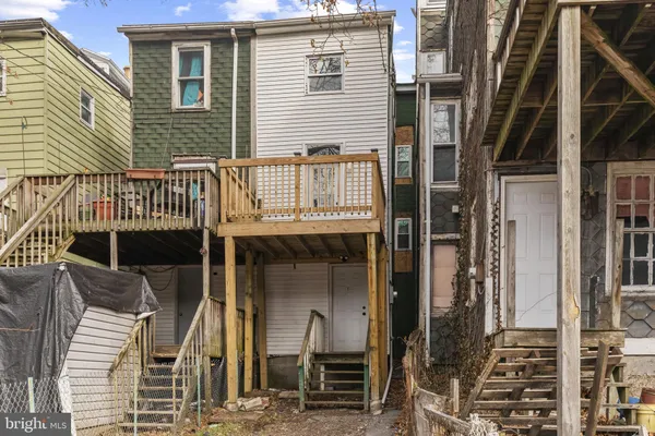 a view of a house with wooden deck