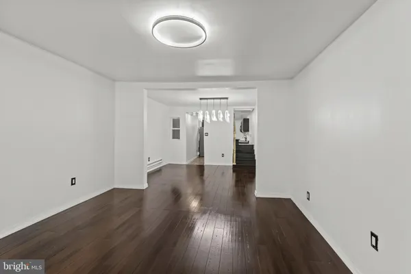 a view of a room with wooden floor and a window