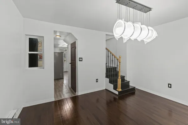 a view of a room with wooden floor