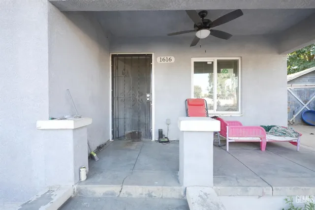 a living room with furniture a flat screen tv and a window
