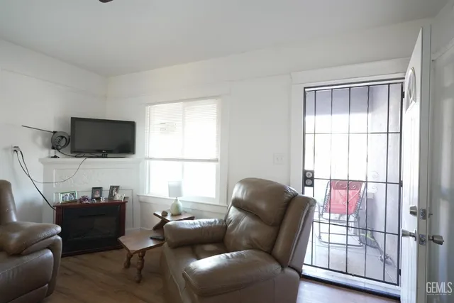 a living room with furniture a window and a flat screen tv