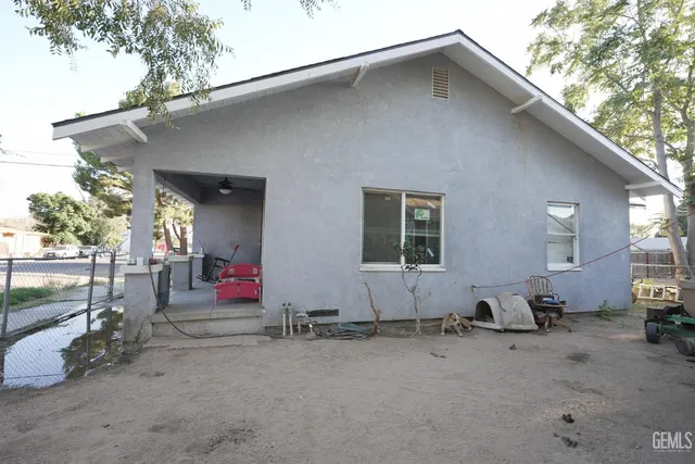 a view of a small yard with wooden fence